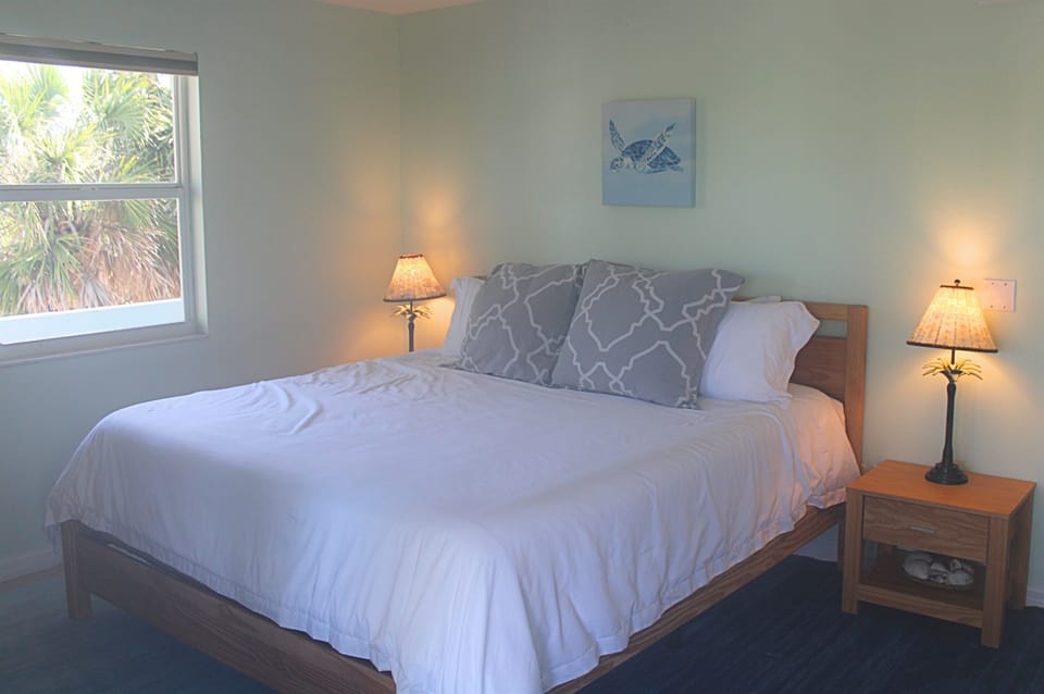 Bedroom 2: Relax in a serene space on a king bed with plush bedding and tropical views!