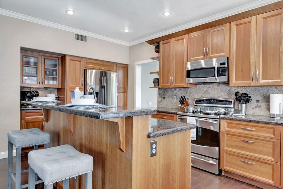Kitchen with stainless steel appliances and bar island for 2 people