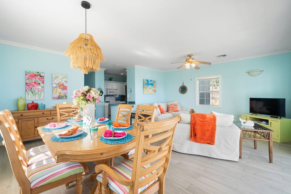 The colorful dining room offers a true  island vibe with seating for 6. 