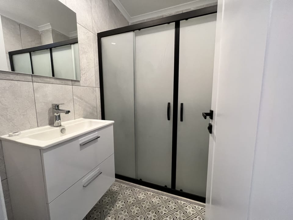 Shower, hair dryer, slippers, towels