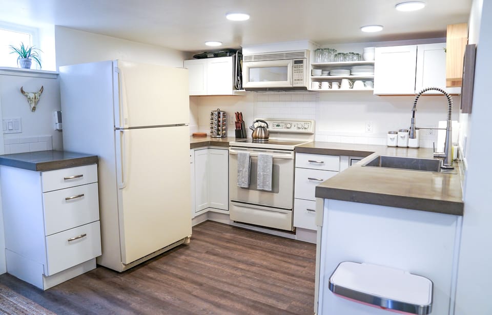 Fully stocked kitchen with spices, basic supplies.