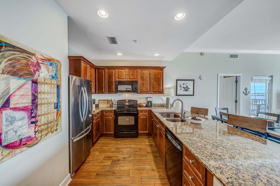 Kitchen also features large refrigerator.
