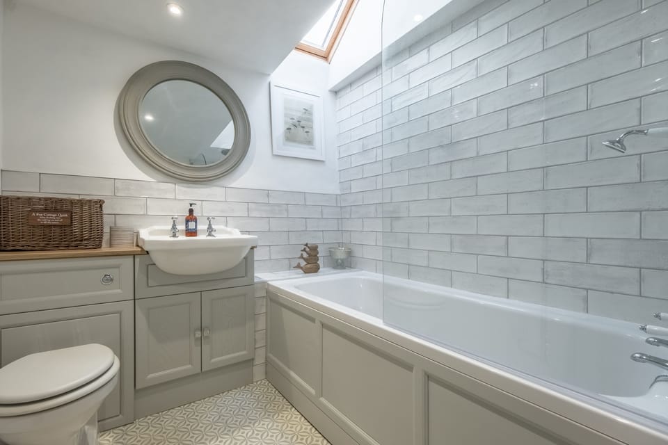 First floor: Bathroom with bath and overhead shower