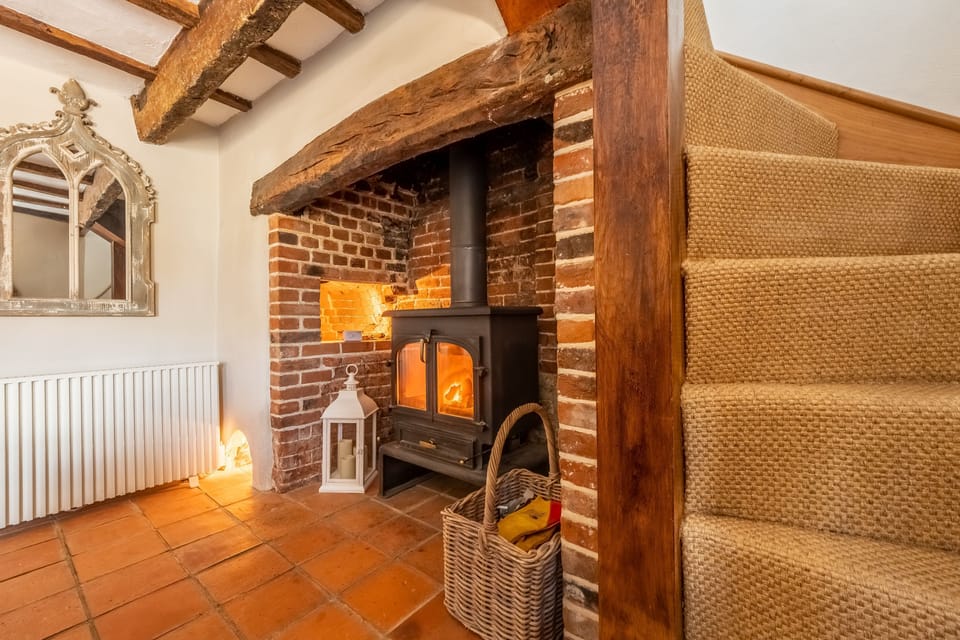Ground floor: Sitting room leading up the Norfolk winder stairs to the first floor