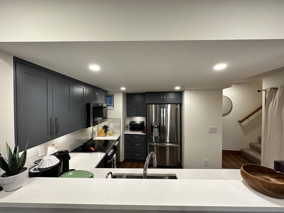 Chef kitchen with Italian tiled backsplash and all white stone countertops.
