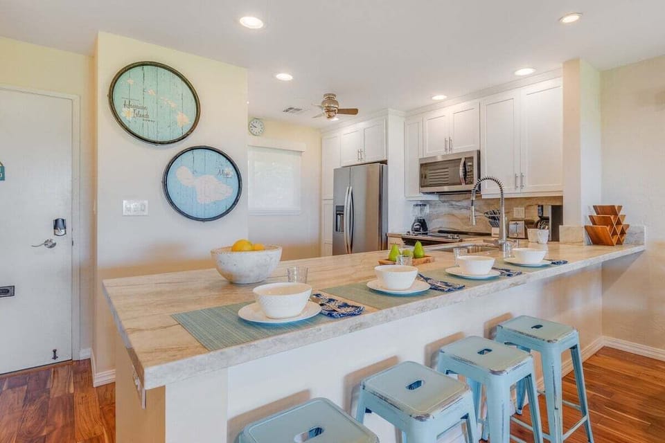 Bright and spacious kitchen with a breakfast bar and stylish wall accents for a welcoming touch