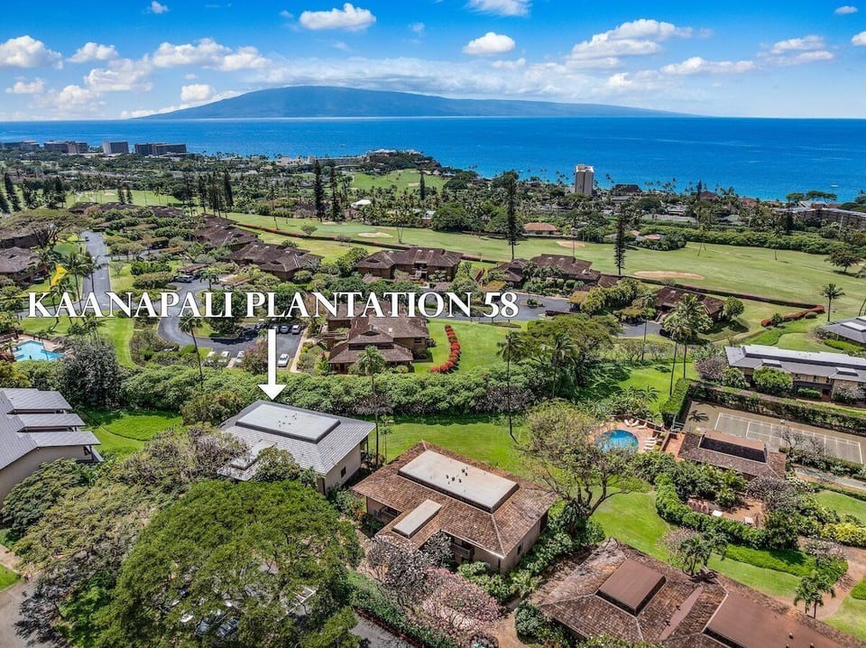 Stunning aerial view of Kaanapali Plantation, showcasing lush greenery, golf course fairways, and sparkling ocean waters