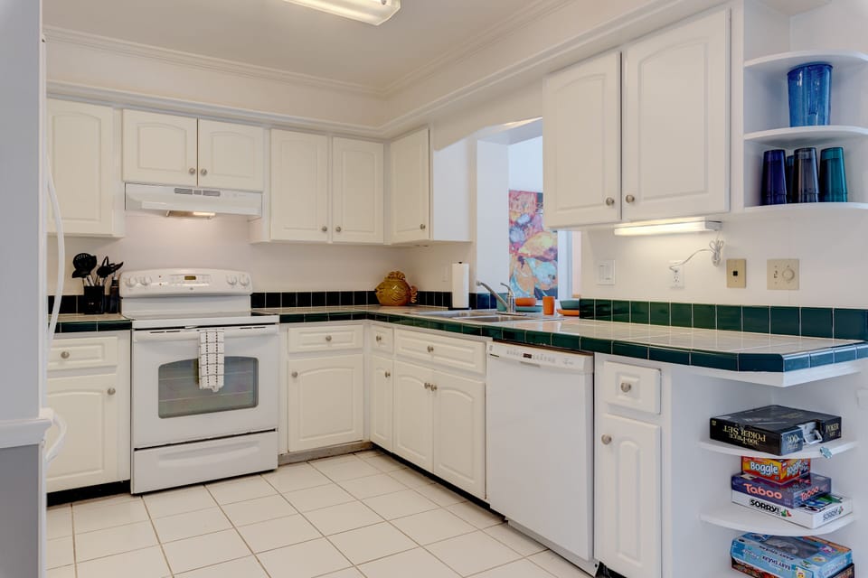 Full stocked kitchen with new appliances and utensils and lots of glassware.