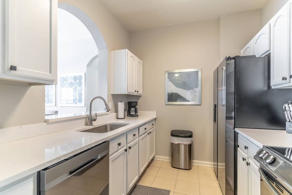 Stainless Steel Appliances and Quartz Counter Tops Grace This Kitchen Area