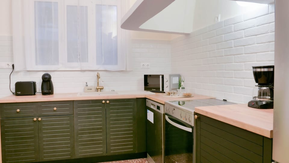 Fully equipped green styled kitchen