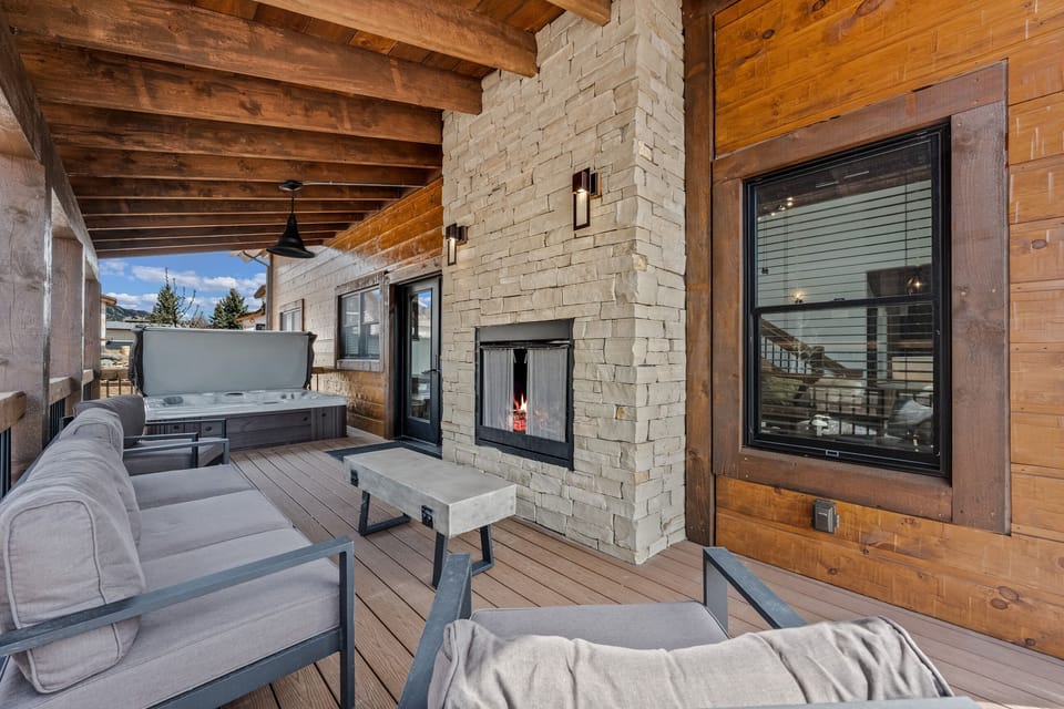 Outdoor patio with fireplace and private hot tub