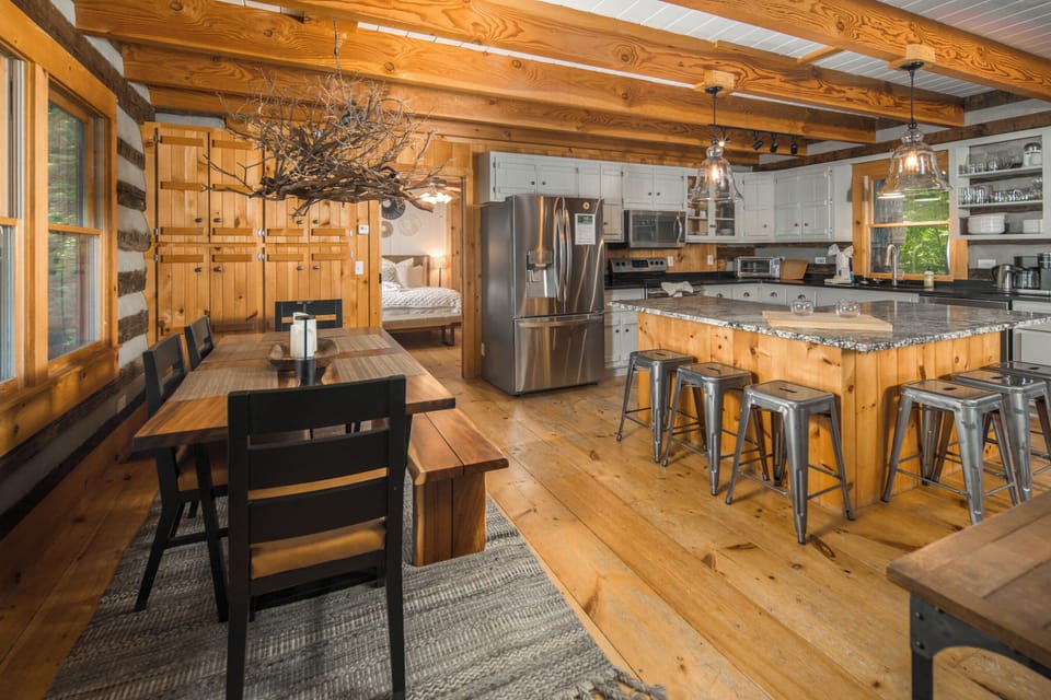 Gather around the dining table and spacious kitchen island in this warm and welcoming open-concept living space