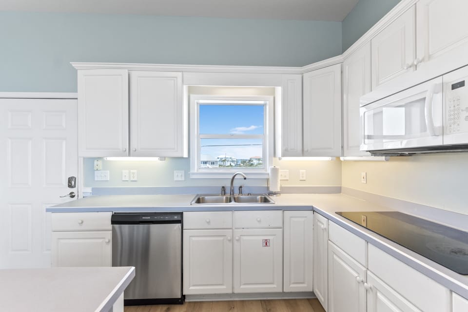 The well equipped kitchen has plenty of light from the sound fac