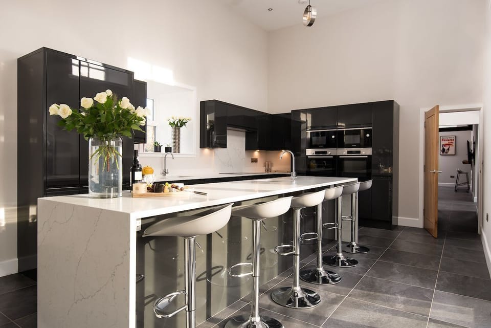 The Steading at West Lyham - contemporary monochrome kitchen with large island and breakfast bar