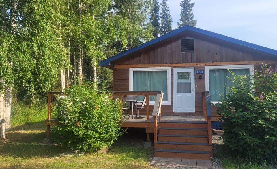 Exterior (during summer), deck, and entrance. 