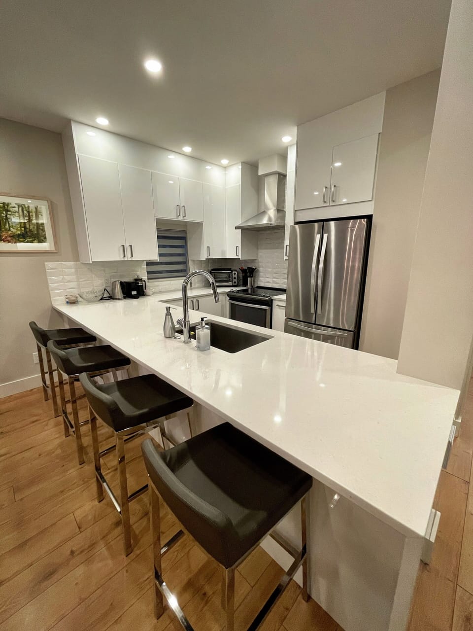 Open concept kitchen with quarts countertop and stainless steel appliances