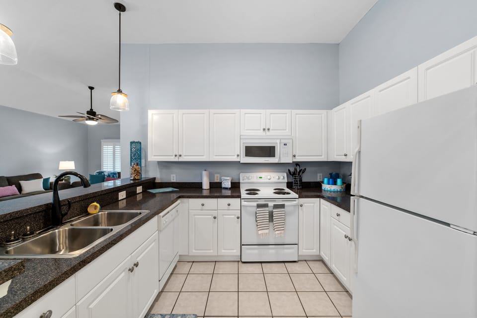 Spacious kitchen with breakfast bar fully stocked with full-size appliances