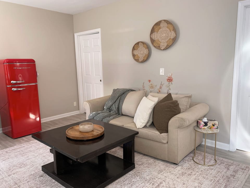 Cozy lounge with stylish decor and a fun retro red fridge