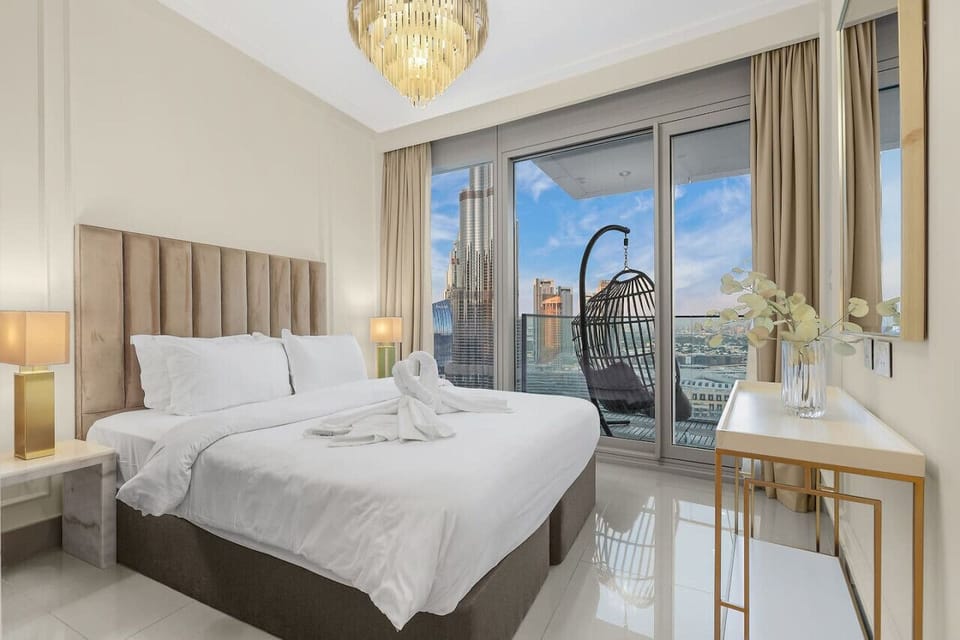 Luxury Bedroom: Unwind in elegance with stunning skyline views and a chic hanging chair!
