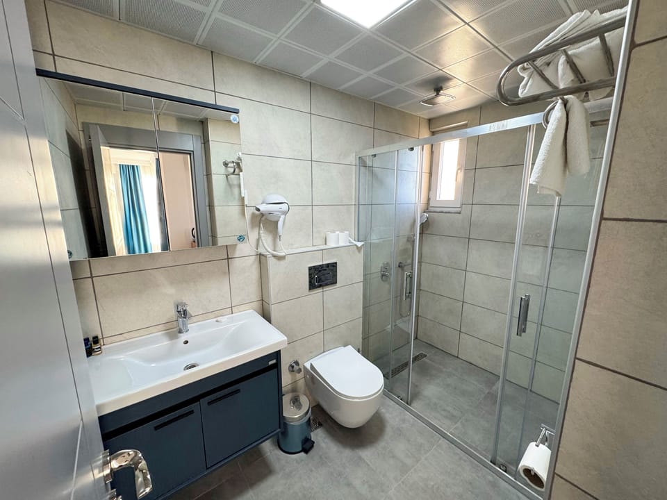 Shower, hair dryer, slippers, towels