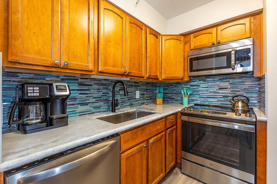 Your fully equipped kitchen features stainless steel appliances, a stylish tiled backsplash, and everything you need to prepare delicious meals during your stay.