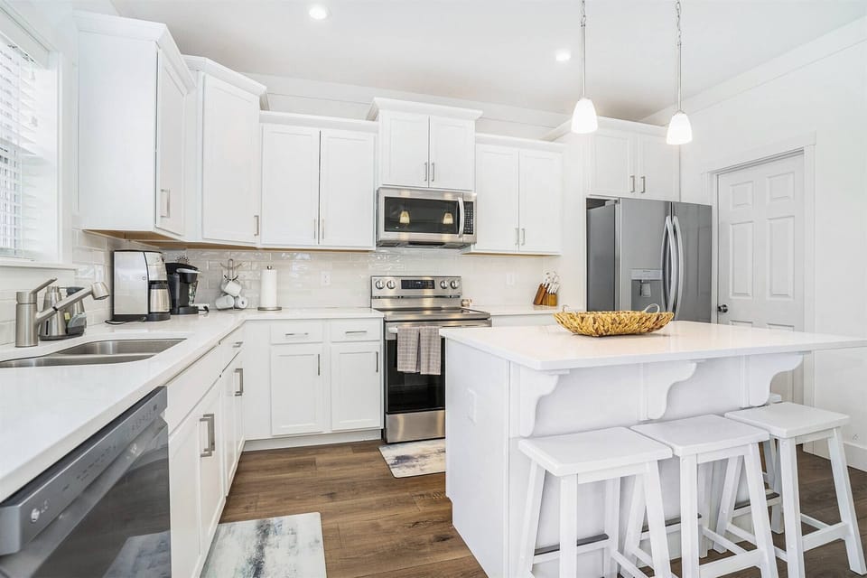 Fully equipped kitchen with stainless steel appliances, and large island