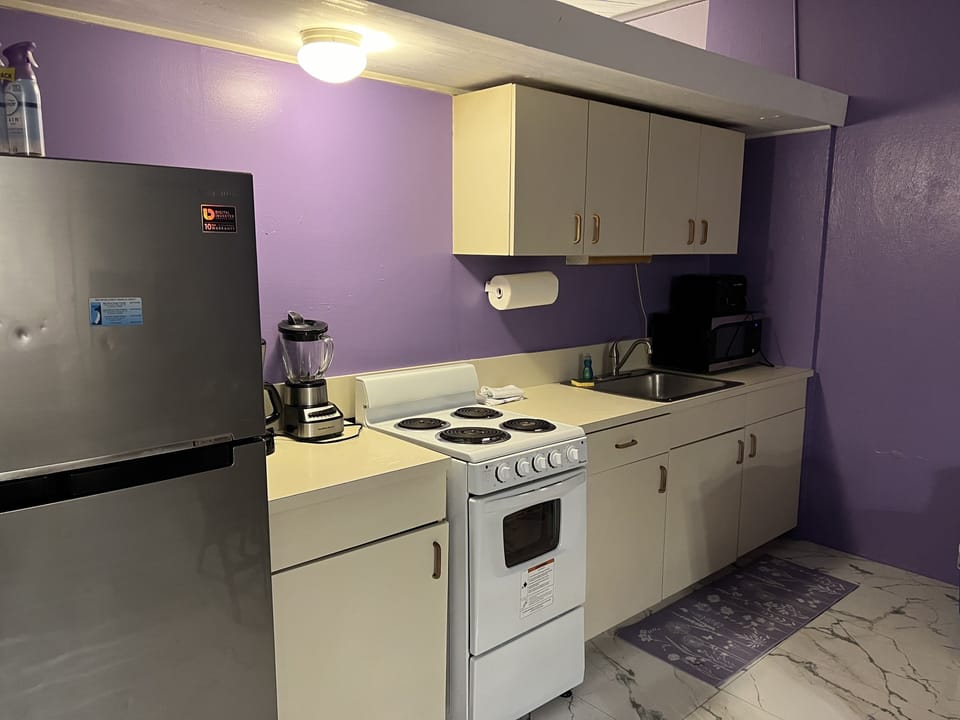 Well-equipped Kitchen with blender, toaster, microwave. drip coffee maker.