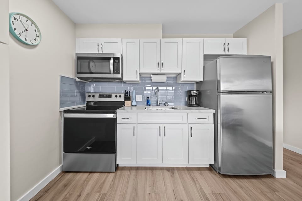 Full kitchen with essentials: coffee maker, pots, pans, toaster, dishware, etc.