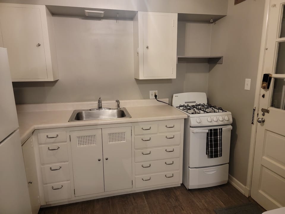 Kitchen w/essentials, microwave, stove, oven, refrigerator, freezer, coffee machine