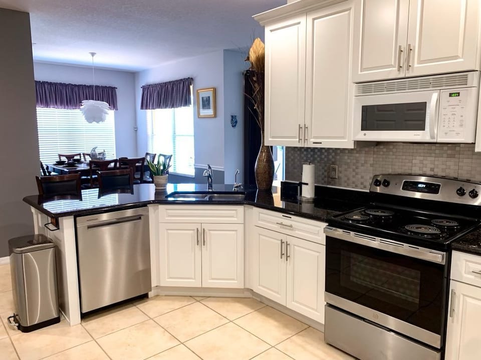 Gourmet kitchen with water filtering system, air fryer, and a rack of spices