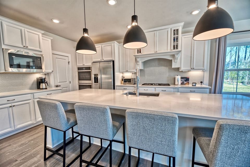 Chef Inspired Kitchen: Quartz countertops, premium cabinetry, and high-end appliances make meal prep a breeze.