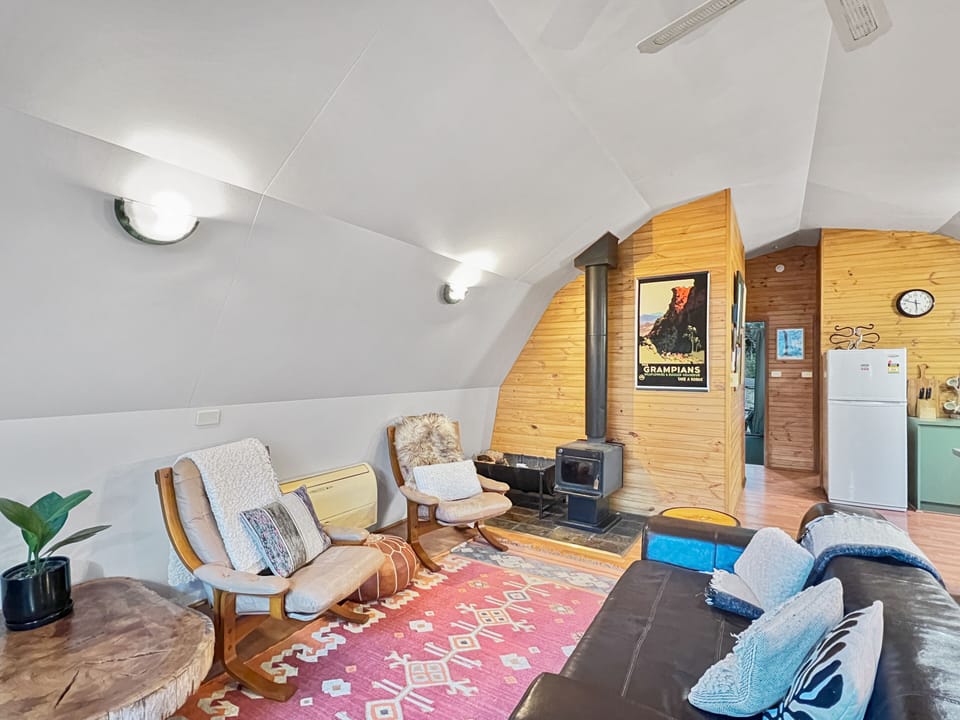 Cozy up in our living area with a charming wood fire for a delightful stay.