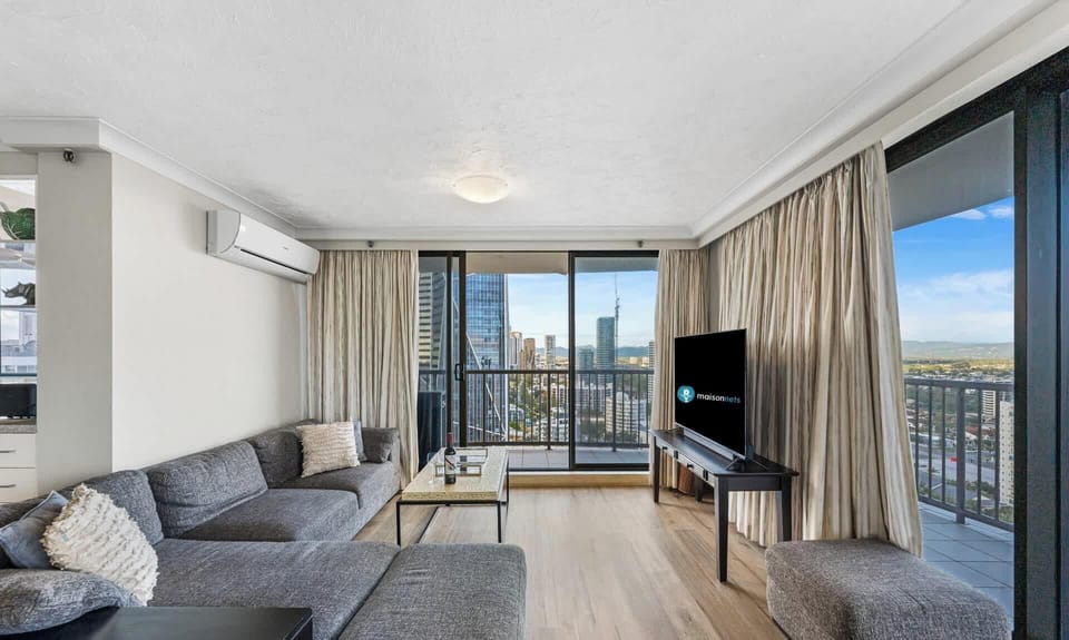 Living room nook with comfy modular lounge, smart TV and views over the Gold Coast's hinterland