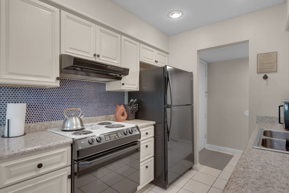 The kitchen is fully stocked with essentials and dinnerware for your stay.