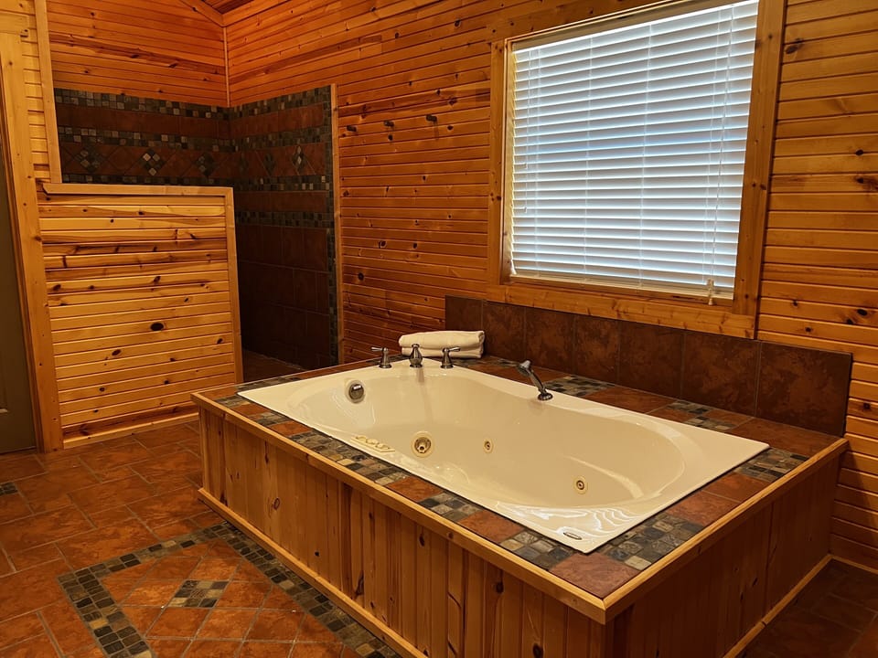 Separate soaking tub and large walk in shower shared by bedroom 1&2