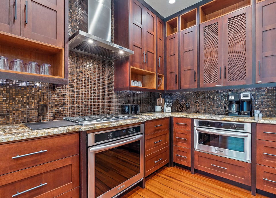 Beautiful stove top and plenty of counter space throughout the entire kitchen.