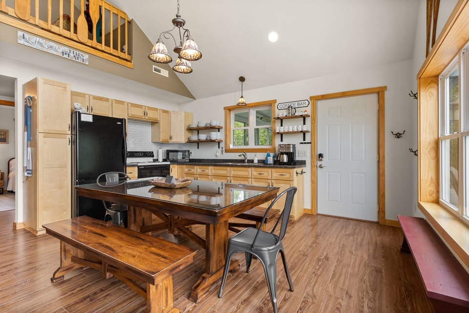 Gather at the farm table for dinner, slide to the kitchen for dessert, and notice the Coffee Bar is already set for morning. The open layout handles a full group without anyone getting in anyone's way.