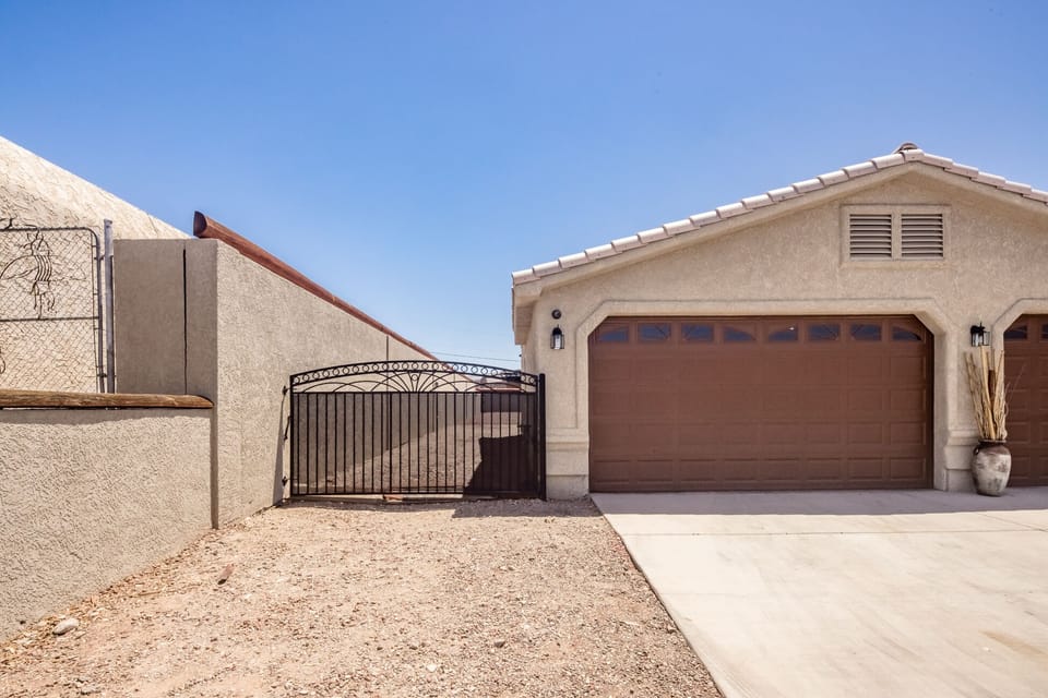Side parking behind gate. Larger toys/vehicles may not fit. No use of garage.