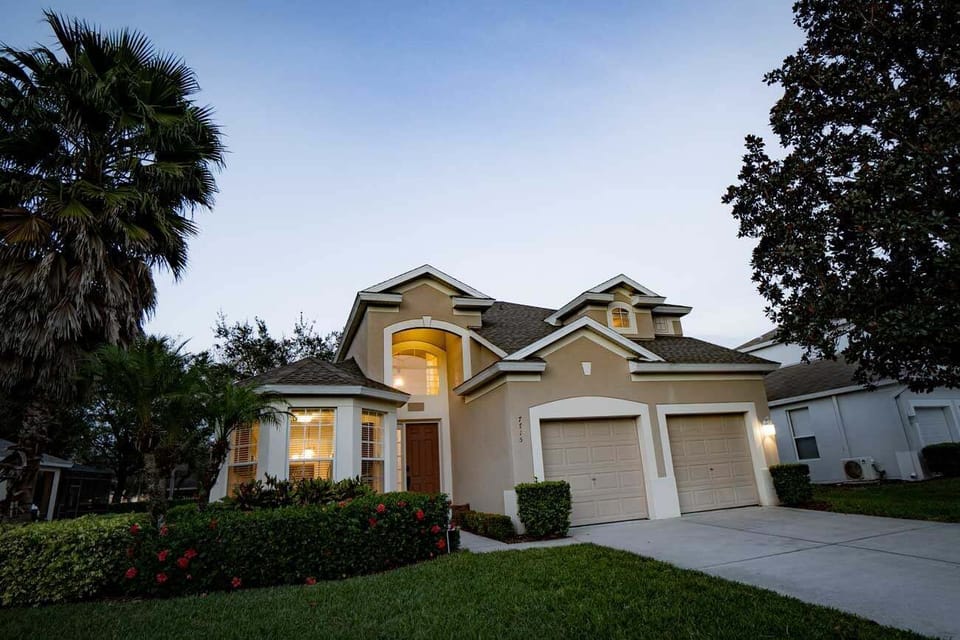 Massive palm tree and magnolia tree frame our beautiful Kissimmee vacation home