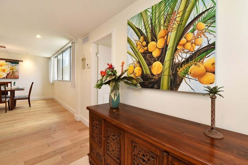 Warm wood finishes and tropical art welcome you into this light-filled hallway.