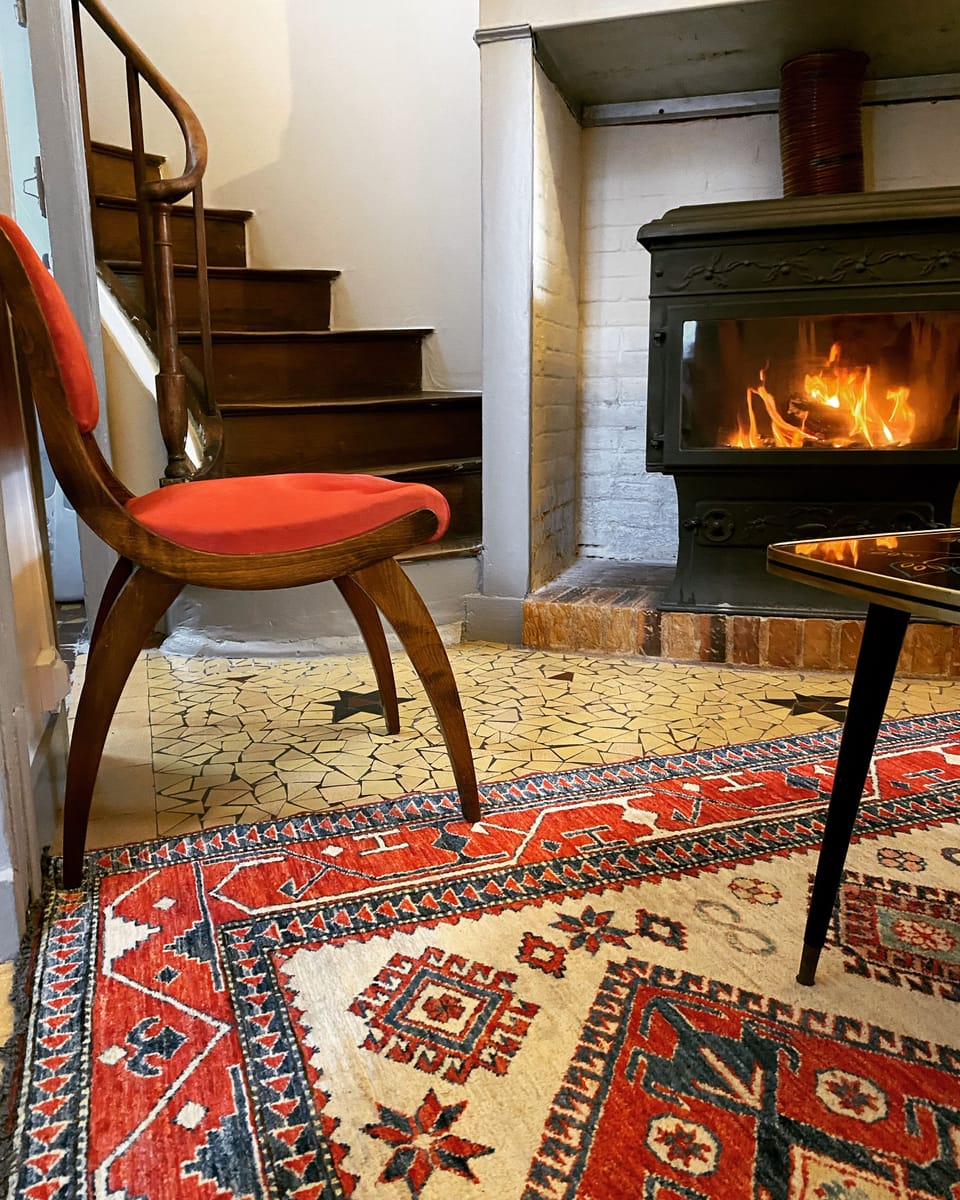 Original elm spiral staircase and terrazzo floor paired with 19thC furnishings