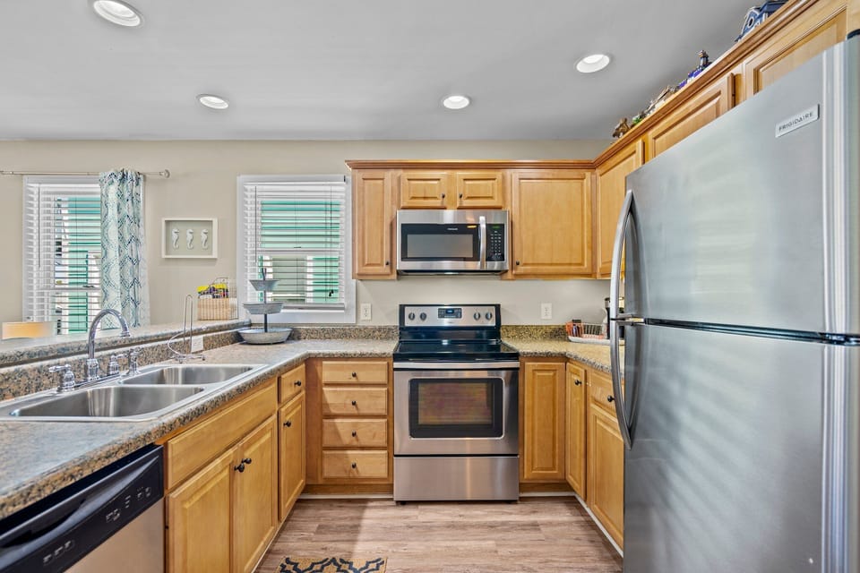 Your fully equipped kitchen features granite counters, stainless appliances, and warm wood cabinets for cooking memorable meals.