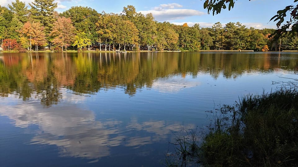 Early Fall makes House Pond glow. As seen from the flagstone patio and boat launch.