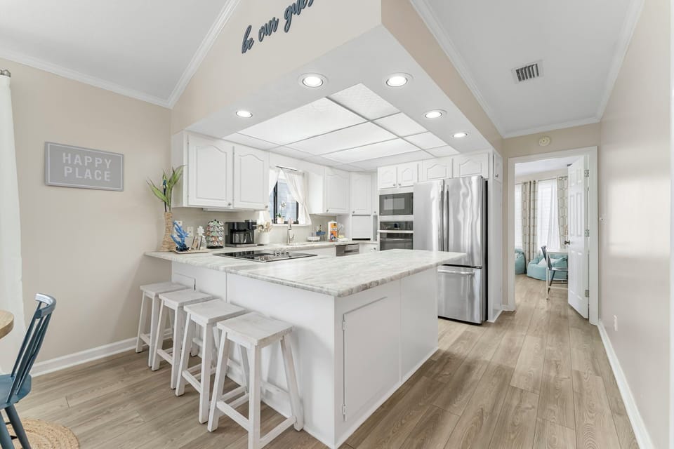  4 bar stools in addition to dining chairs gives enough room for the family