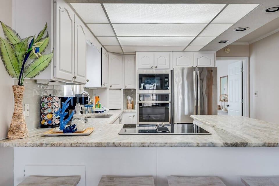 Fully equipped kitchen with stainless steel , oven and electric cooktop