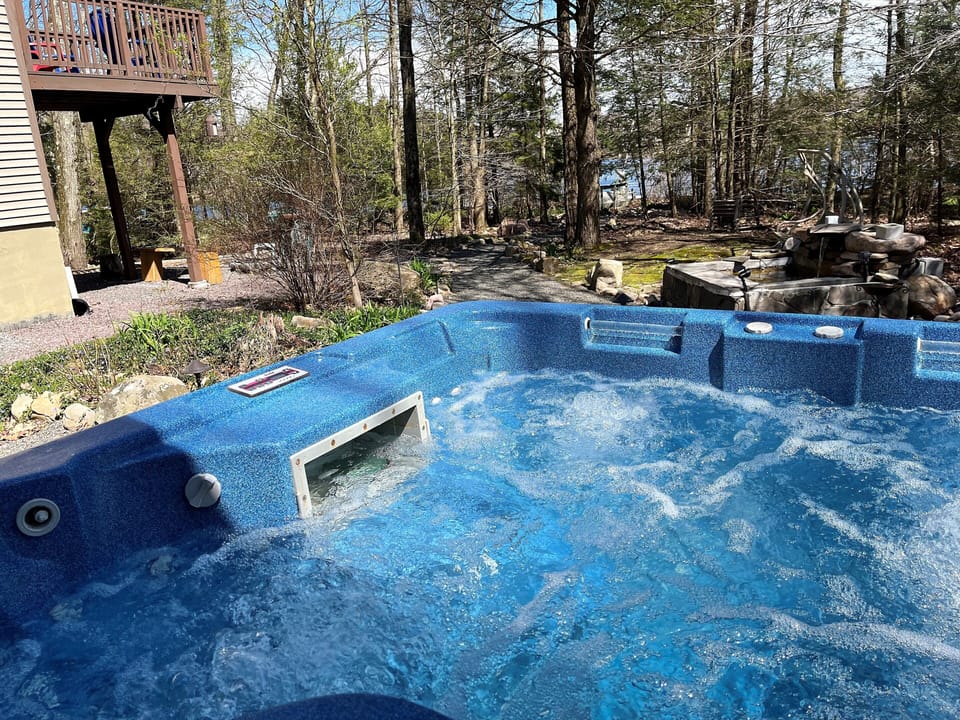 Enjoy the wooded lake view right from the hot tub!