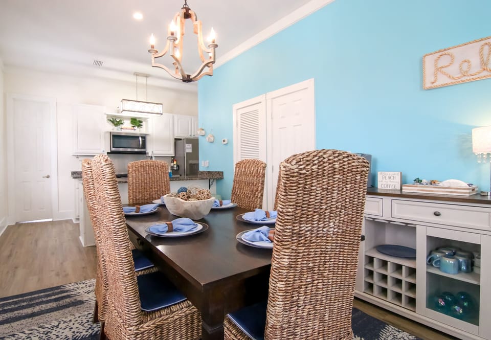 Dining area with coffee bar & shared half bath — open-plan and bright
