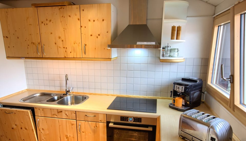 fully equipped kitchen with induction hob, oven, fully automatic coffee machine, Dualit toaster and more