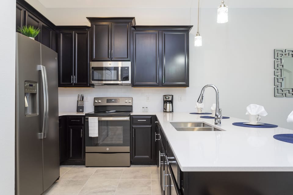 Family Townhome, 2 Bedrooms | Private kitchen | Full-size fridge, microwave, oven, stovetop