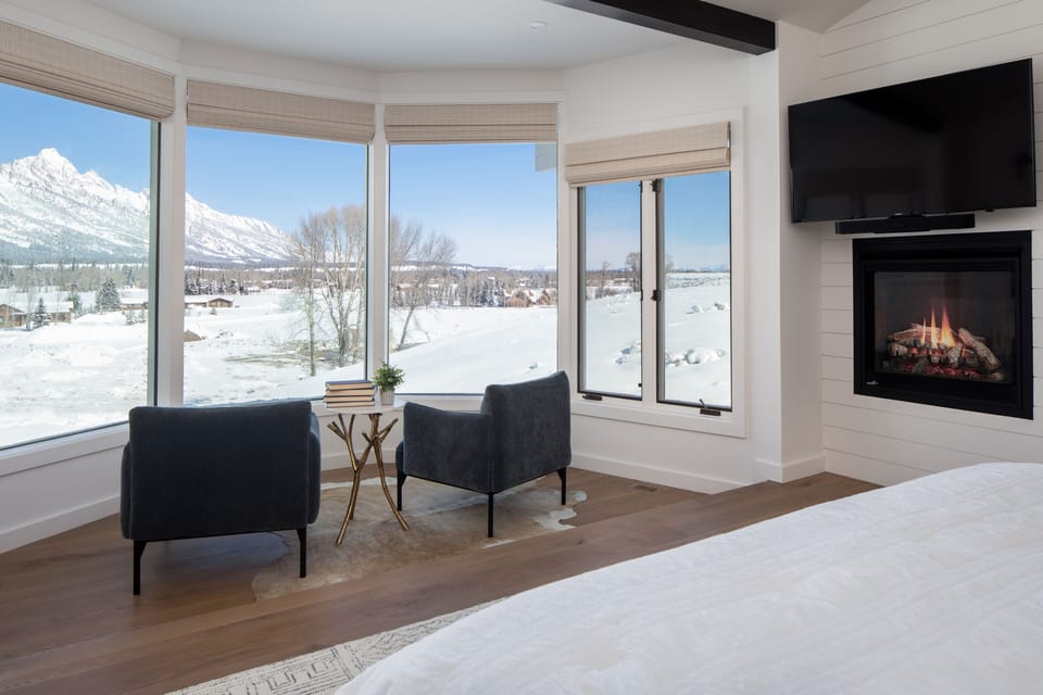 Main bedroom seating area with fireplace and views